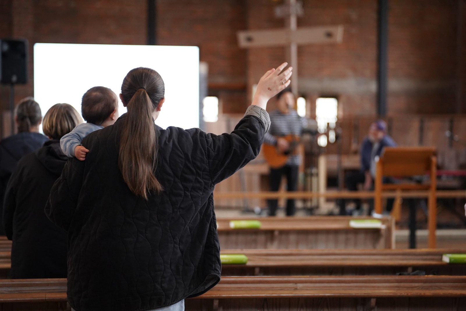 A parent and child worshipping at William Temple Church